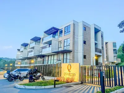 a building with two motorcycles parked in front of it at Modern 2BR 3Bed Country Suite | El Retiro, Ant in El Retiro