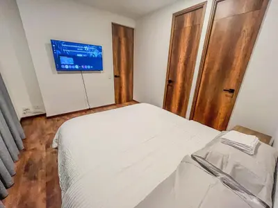 a bedroom with a bed and a tv on the wall at Modern 2BR 3Bed Country Suite | El Retiro, Ant in El Retiro