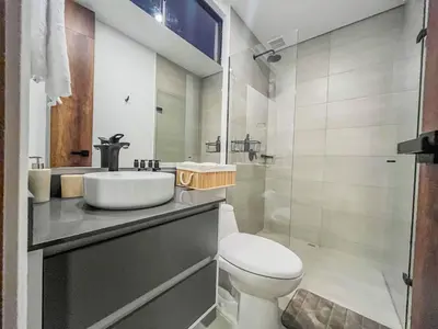a bathroom with a toilet and a sink and a shower at Modern 2BR 3Bed Country Suite | El Retiro, Ant in El Retiro