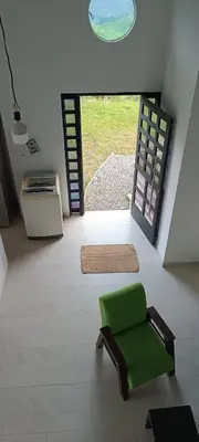 a green chair in a living room with a door at Villa Adelaida in San Rafael