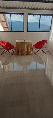 a room with a table and two red chairs at Villa Adelaida in San Rafael