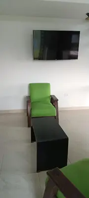 a green chair in a room with a mirror at Villa Adelaida in San Rafael