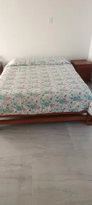 a bed with a quilt on it in a bedroom at Villa Adelaida in San Rafael