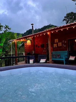 a pool of water in front of a house at Casa de campo Happy Hill in Cocorná