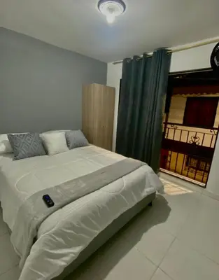 a bedroom with a large bed with a window at Apartamentos SAN LUIS in San Luis