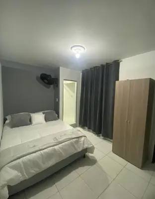 a bedroom with a bed and a wooden cabinet at Apartamentos SAN LUIS in San Luis