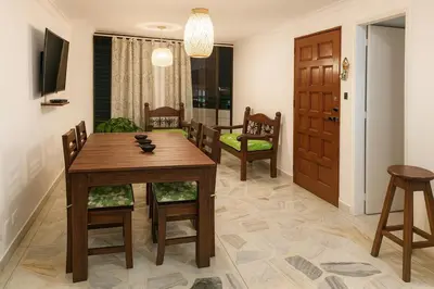 a dining room with a wooden table and chairs at Oasis in Manila - El Poblado Estilo y Comfort in Medellín