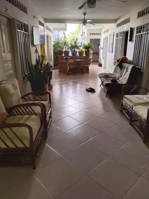 a living room with chairs and a tiled floor at hotel morichal in Puerto Boyacá