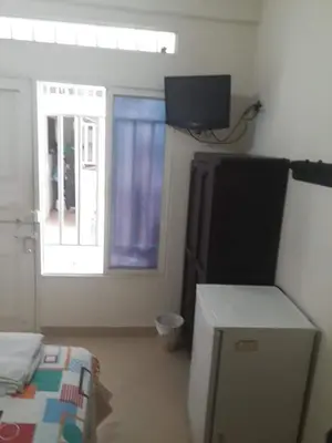 a room with a bed and a television and a window at hotel morichal in Puerto Boyacá