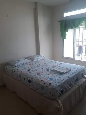 a bed in a bedroom with a window at hotel morichal in Puerto Boyacá