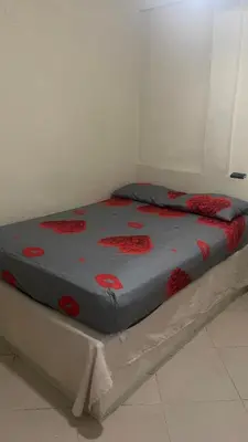 a bed with red flowers on it in a room at hotel morichal in Puerto Boyacá