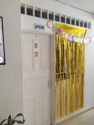a room with a white door with a yellow curtain at hotel morichal in Puerto Boyacá