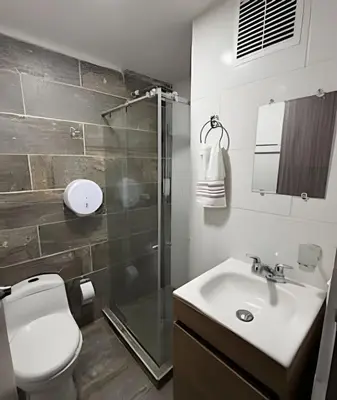 a bathroom with a toilet and a sink and a shower at Cómodo Apartamento - Estrato 5 in Manizales