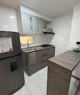 a small kitchen with a sink and a refrigerator at Cómodo Apartamento - Estrato 5 in Manizales