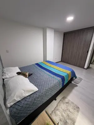 a bedroom with a bed in a room at Cómodo Apartamento - Estrato 5 in Manizales