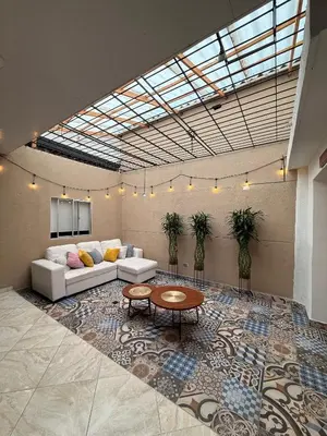 a living room with a couch and a table at Hostal Pacifico Encanto in Medellín