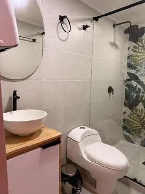a bathroom with a toilet and a sink at Hostal Pacifico Encanto in Medellín