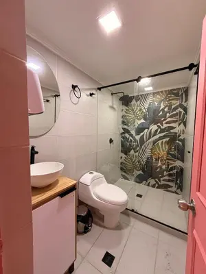 a bathroom with a toilet and a sink at Hostal Pacifico Encanto in Medellín