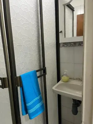 a bathroom with a sink and a blue towel at Apartamento en el centro de Manizales in Manizales