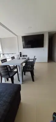 a dining room with a white table and chairs at Espectacular Apto Citadela Di Sole Santafe de Antioquia in Santa Fe de Antioquia