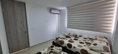 a bedroom with a cow print bed and a window at Espectacular Apto Citadela Di Sole Santafe de Antioquia in Santa Fe de Antioquia