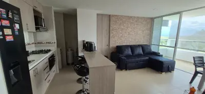 a kitchen with a couch and a chair in a room at Espectacular Apto Citadela Di Sole Santafe de Antioquia in Santa Fe de Antioquia