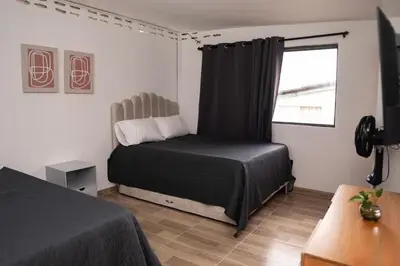 a bedroom with a bed and a window at Very spacious house one block from the park in San Luis