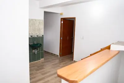 a bathroom with a sink and a wooden counter at Very spacious house one block from the park in San Luis