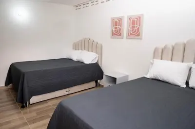 a bedroom with two beds in a room at Very spacious house one block from the park in San Luis