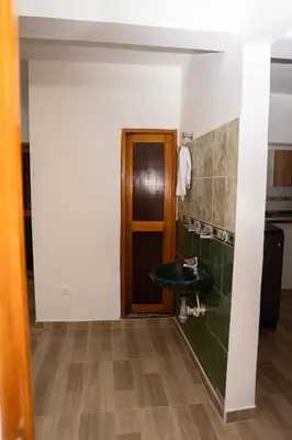 a bathroom with a sink and a door at Very spacious house one block from the park in San Luis