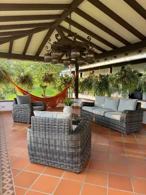 a group of couches and chairs on a patio at La juana cerro tusa in Venecia