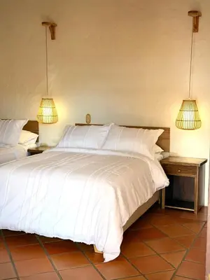 a bedroom with two white beds and two lamps at La juana cerro tusa in Venecia
