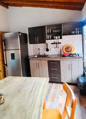a kitchen with a wooden table and a refrigerator at Family accommodation in downtown Itagüí in Itagüí