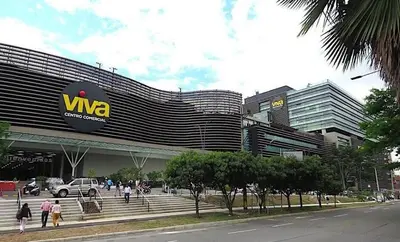 a building with people walking in front of it at Family accommodation in downtown Itagüí in Itagüí