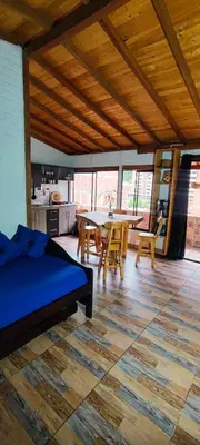 a room with a bed and a table and chairs at Family accommodation in downtown Itagüí in Itagüí