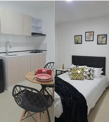 a bedroom with a bed and a table and a kitchen at apartaestudios completos in Manizales