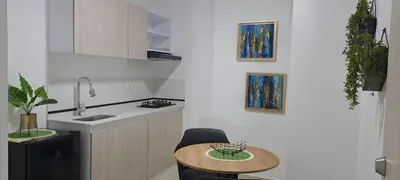 a kitchen with a small table and a sink at apartaestudios completos in Manizales