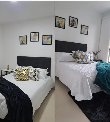 a bedroom with two beds with pillows on them at apartaestudios completos in Manizales