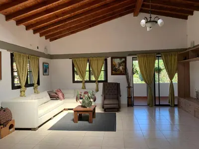 a living room with a white couch and a table at Finca coraline in Guarne