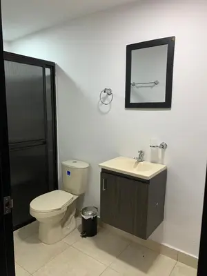 a bathroom with a toilet and a sink and a mirror at Finca coraline in Guarne