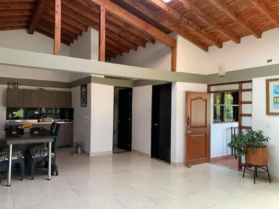 an open kitchen and dining room with a wooden ceiling at Finca coraline in Guarne