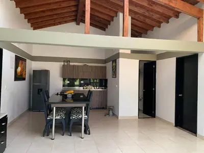 a kitchen with a table and chairs in a room at Finca coraline in Guarne