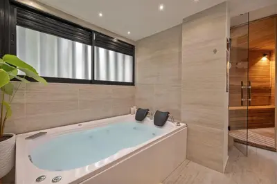 a large bathroom with a tub and a shower at Amazing apartment with Private Luxury Sauna Jacuzzi Steam Room Pool Table in Medellín