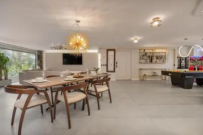 a dining room with a table and a pool table at Amazing apartment with Private Luxury Sauna Jacuzzi Steam Room Pool Table in Medellín