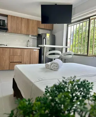 a kitchen with a large bed in a room at Loft Laureles - Excellent location in Medellín