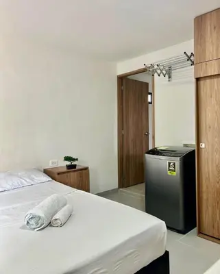 a bedroom with a bed with two towels on it at Loft Laureles - Excellent location in Medellín