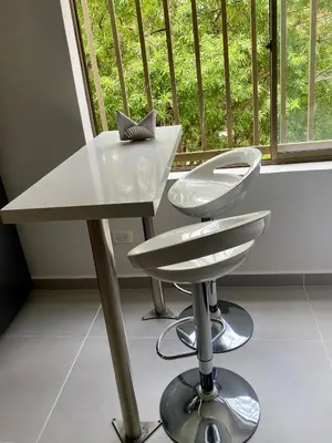 a white desk and a chair in front of a window at Loft Laureles - Moderno y amplio in Medellín