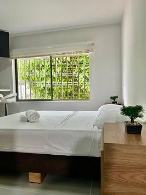 a bedroom with a large bed and a window at Loft Laureles - Moderno y amplio in Medellín