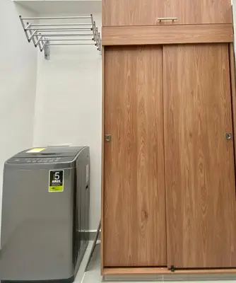 a refrigerator next to a wooden cabinet in a room at Loft - Laureles, interno con patio in Medellín