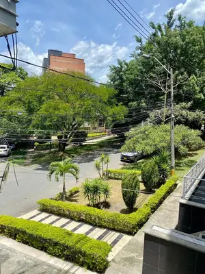 a view of a parking lot with trees and bushes at Loft - Laureles, interno con patio in Medellín